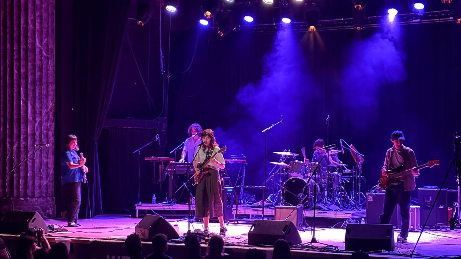 A band performing under purple and white stage lights at WREKtacular 2026, with the audience in front of the stage.